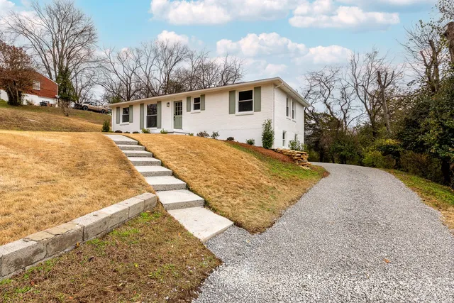 a view of a house with a yard covered in snow