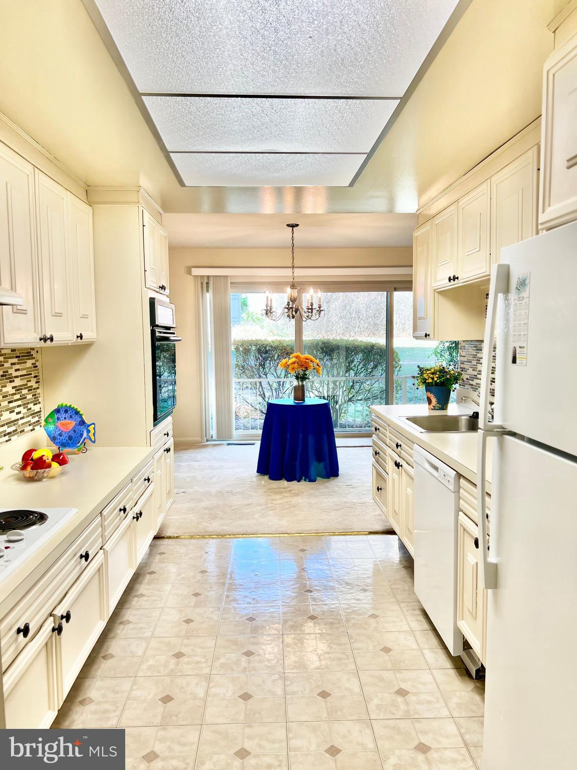 3386 Chiswick Court, Unit 501A Silver Spring, MD 20906 - Photo 1 of 43 a kitchen with kitchen island granite countertop a refrigerator and a stove