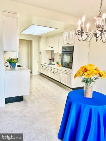 a living room with fireplace furniture and a chandelier