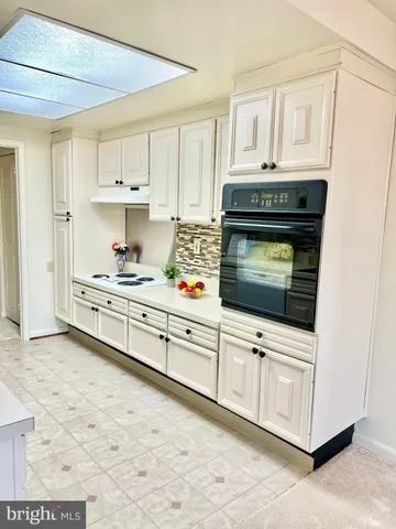a kitchen with stainless steel appliances a stove a microwave and cabinets