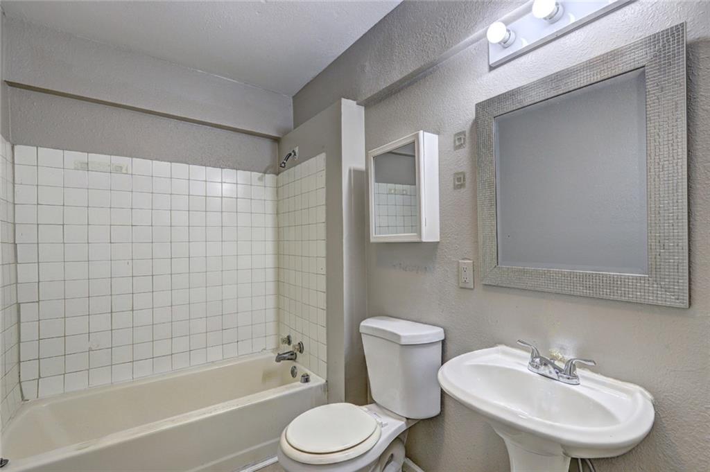 2122 Monroe Avenue Macon, GA 31204 - Photo 12 of 16 a bathroom with a sink toilet and shower