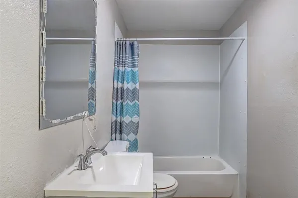 a bathroom with a bathtub and a sink