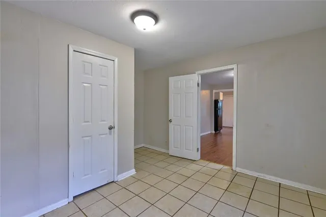 an empty room with windows and closet
