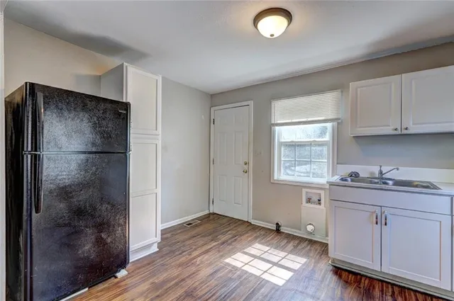 a kitchen with a refrigerator and window