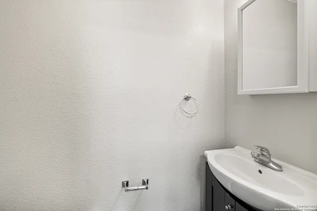 a bathroom with a sink and mirror