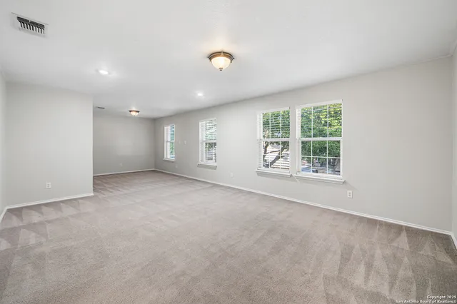 an empty room with windows and entrance