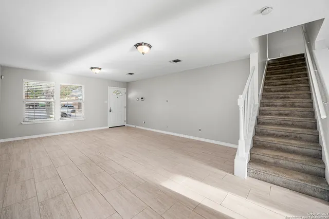 a view of an empty room with a window