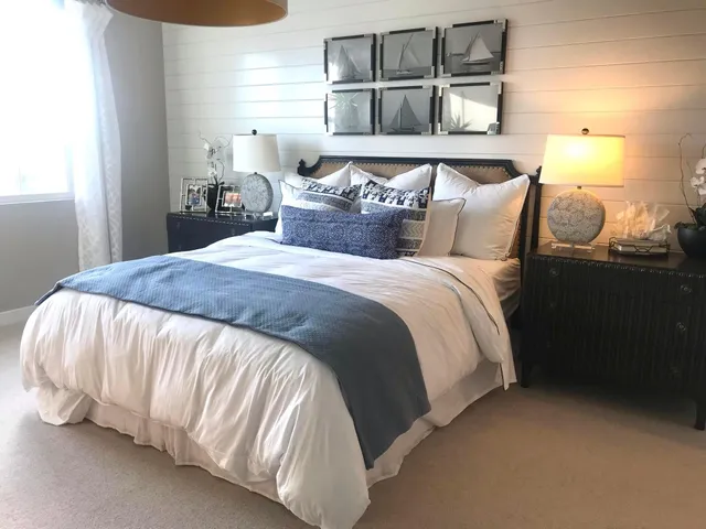 a dining room with furniture a potted plant and wooden floor