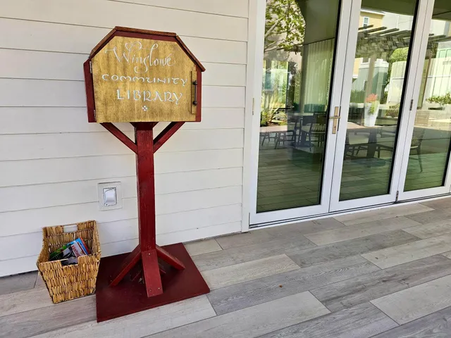 a view of a tables and chairs in patio next to a yard
