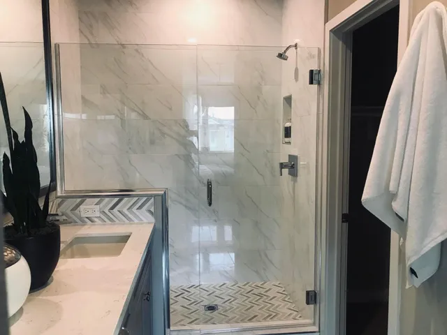 a bathroom with a sink a mirror and shower