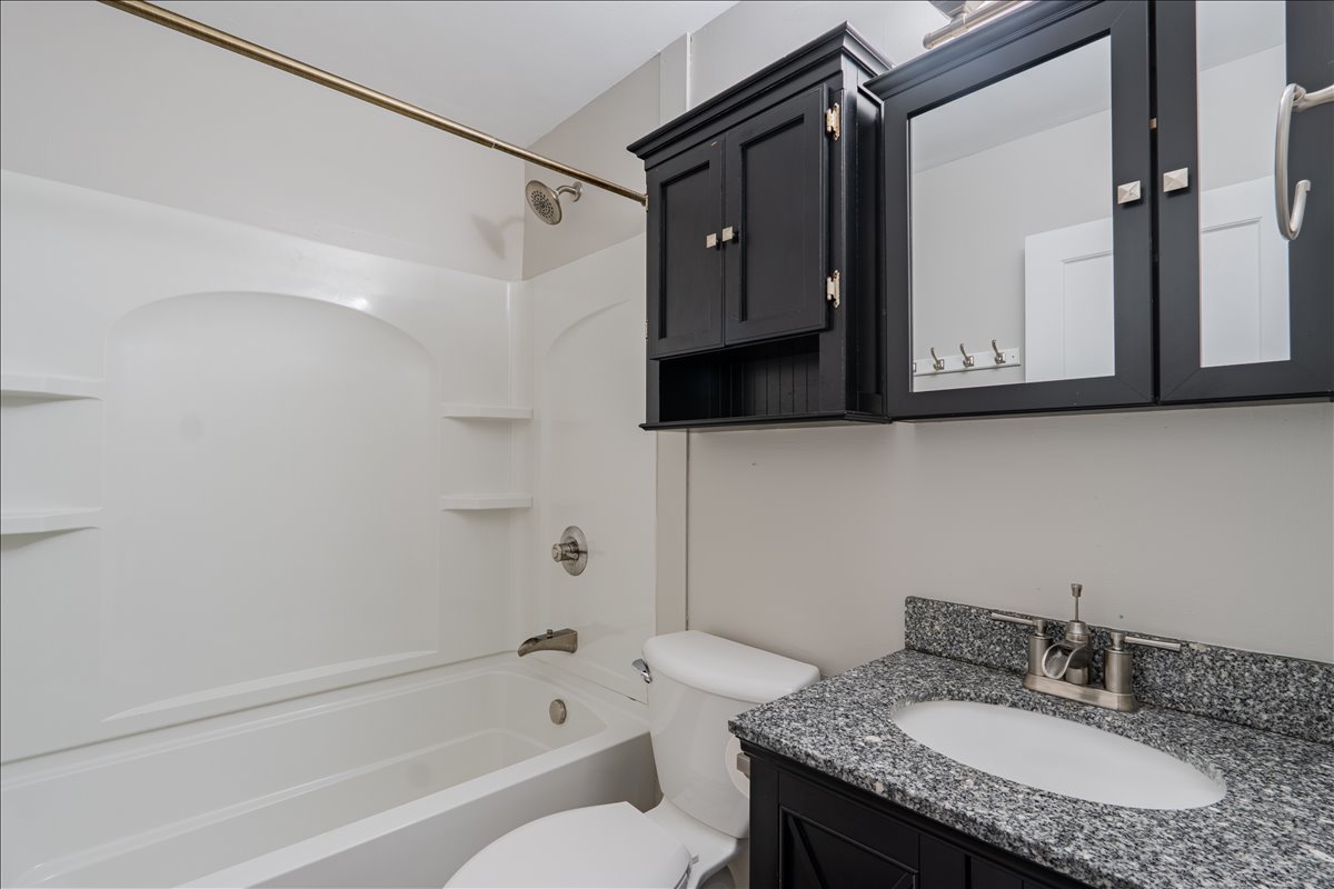 8 Felton Place Bloomington, IL 61701 - Photo 11 of 31 a bathroom with a granite countertop sink toilet and shower