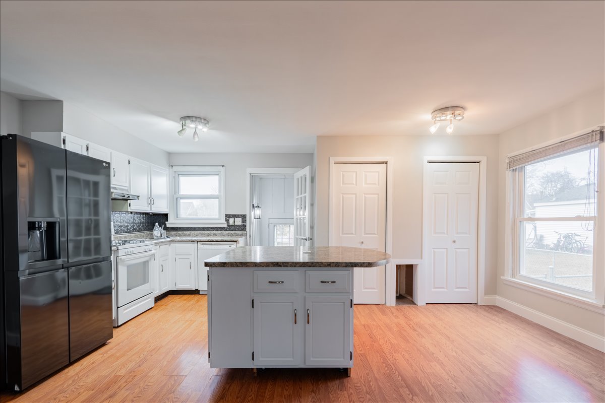 8 Felton Place Bloomington, IL 61701 - Photo 6 of 31 a kitchen with stainless steel appliances granite countertop a refrigerator and a stove top oven