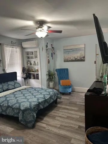 a bedroom with bed and window