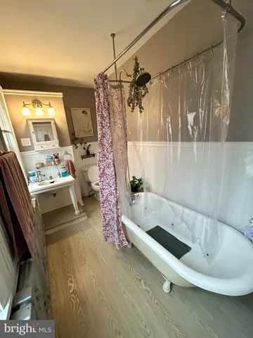 a bathroom with a tub a sink and a shower