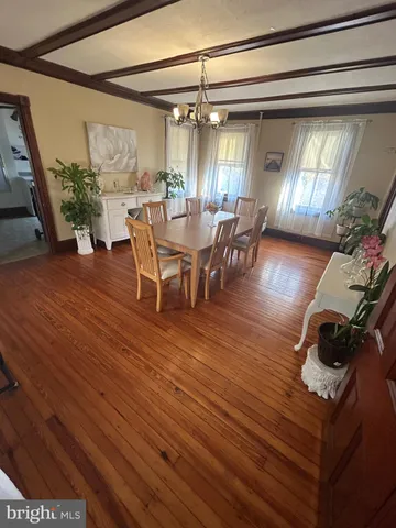 a dining room with furniture and wooden floor