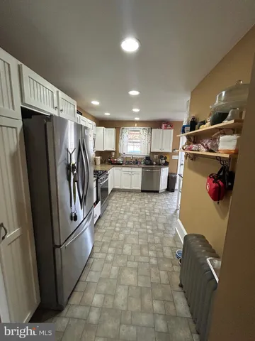 a kitchen with a refrigerator and a sink