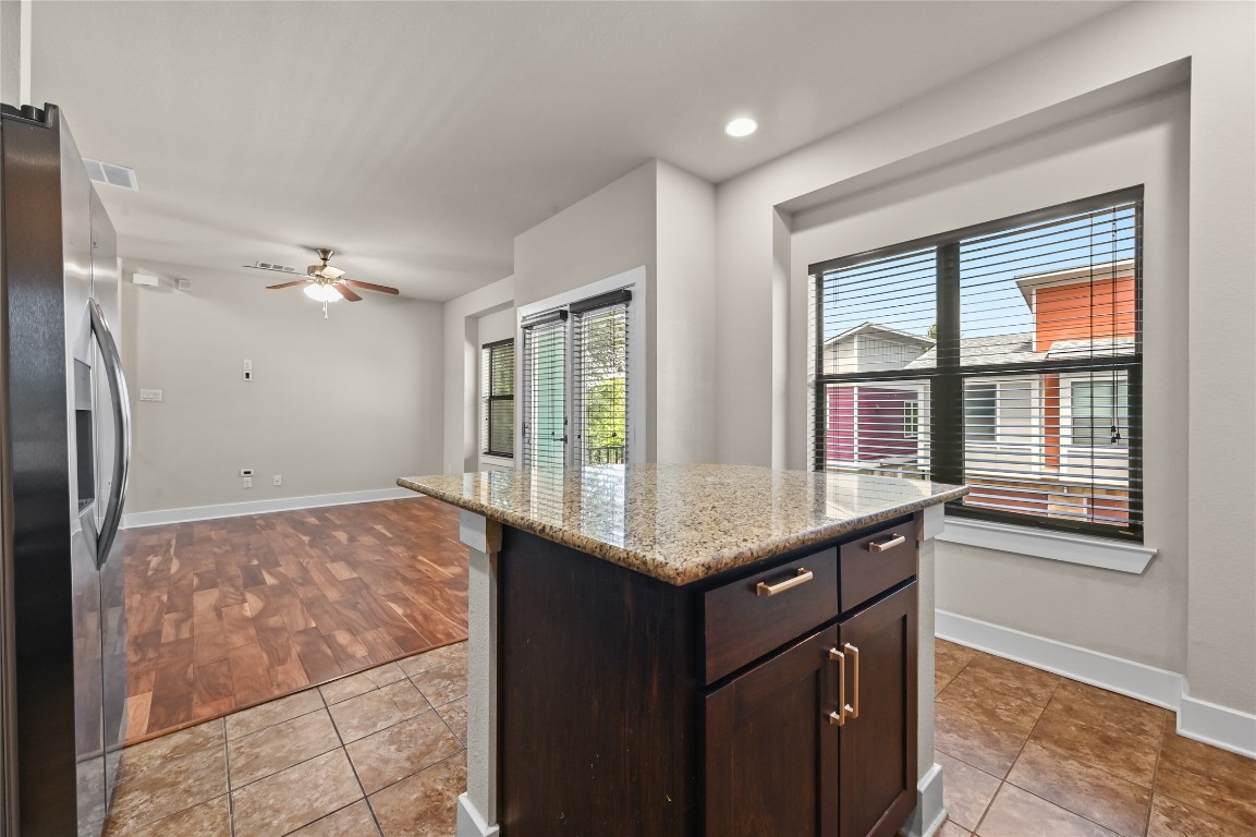 1504 Lorraine Loop, Unit B Austin, TX 78758 - Photo 12 of 25 a kitchen with a sink a refrigerator and window