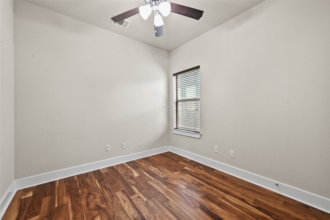 1504 Lorraine Loop, Unit B Austin, TX 78758 - Photo 13 of 25 wooden floor in an empty room with a window
