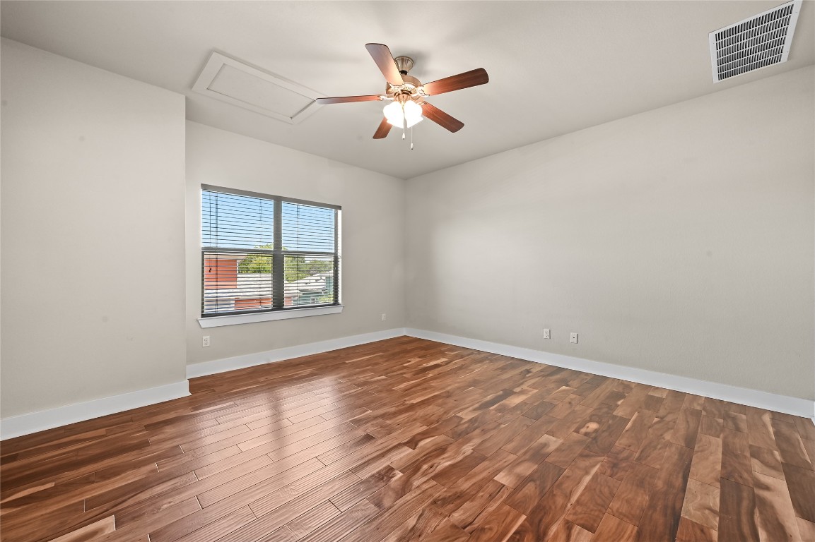 1504 Lorraine Loop, Unit B Austin, TX 78758 - Photo 16 of 25 wooden floor in an empty room with a window