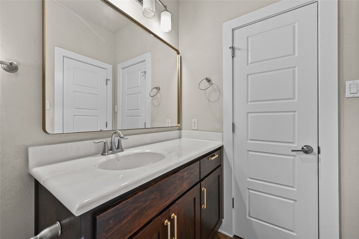 1504 Lorraine Loop, Unit B Austin, TX 78758 - Photo 19 of 25 a bathroom with a sink and a mirror