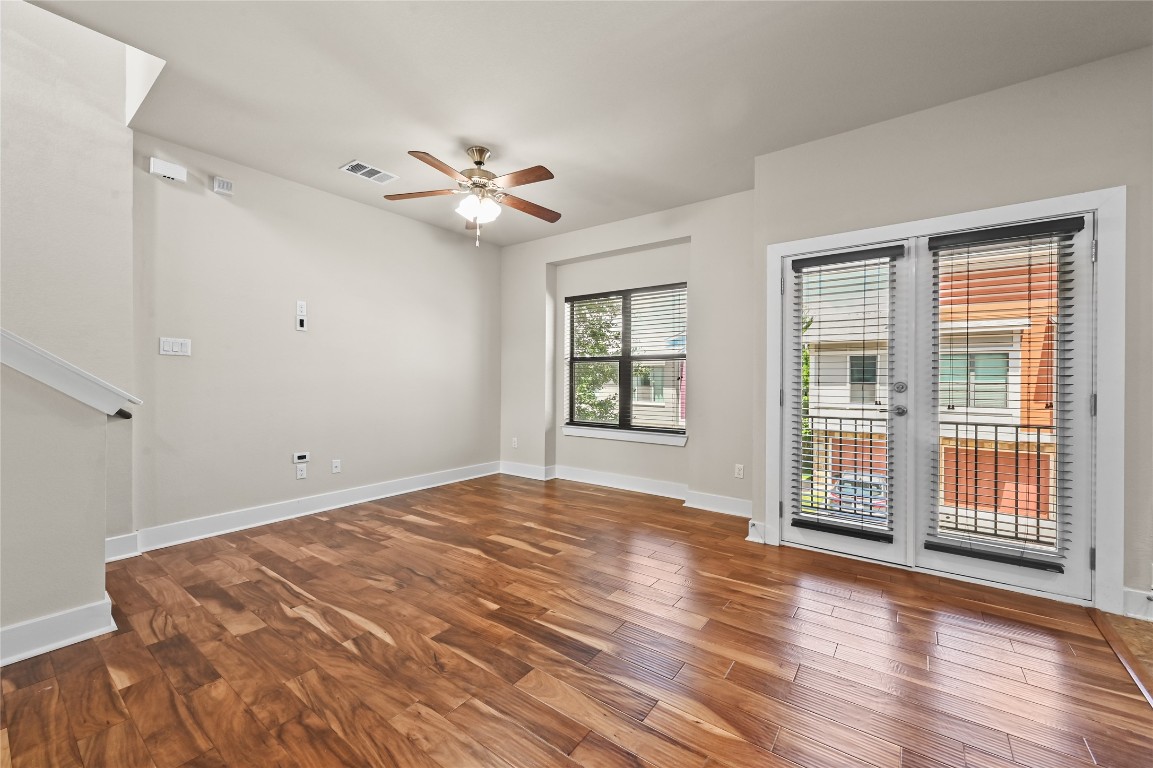 1504 Lorraine Loop, Unit B Austin, TX 78758 - Photo 7 of 25 a view of empty room with wooden floor and fan