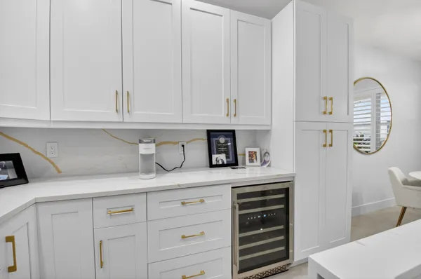 a kitchen with a sink a counter and chairs