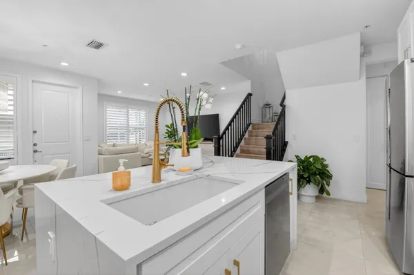 a kitchen with stainless steel appliances white cabinets white stove a microwave and a refrigerator