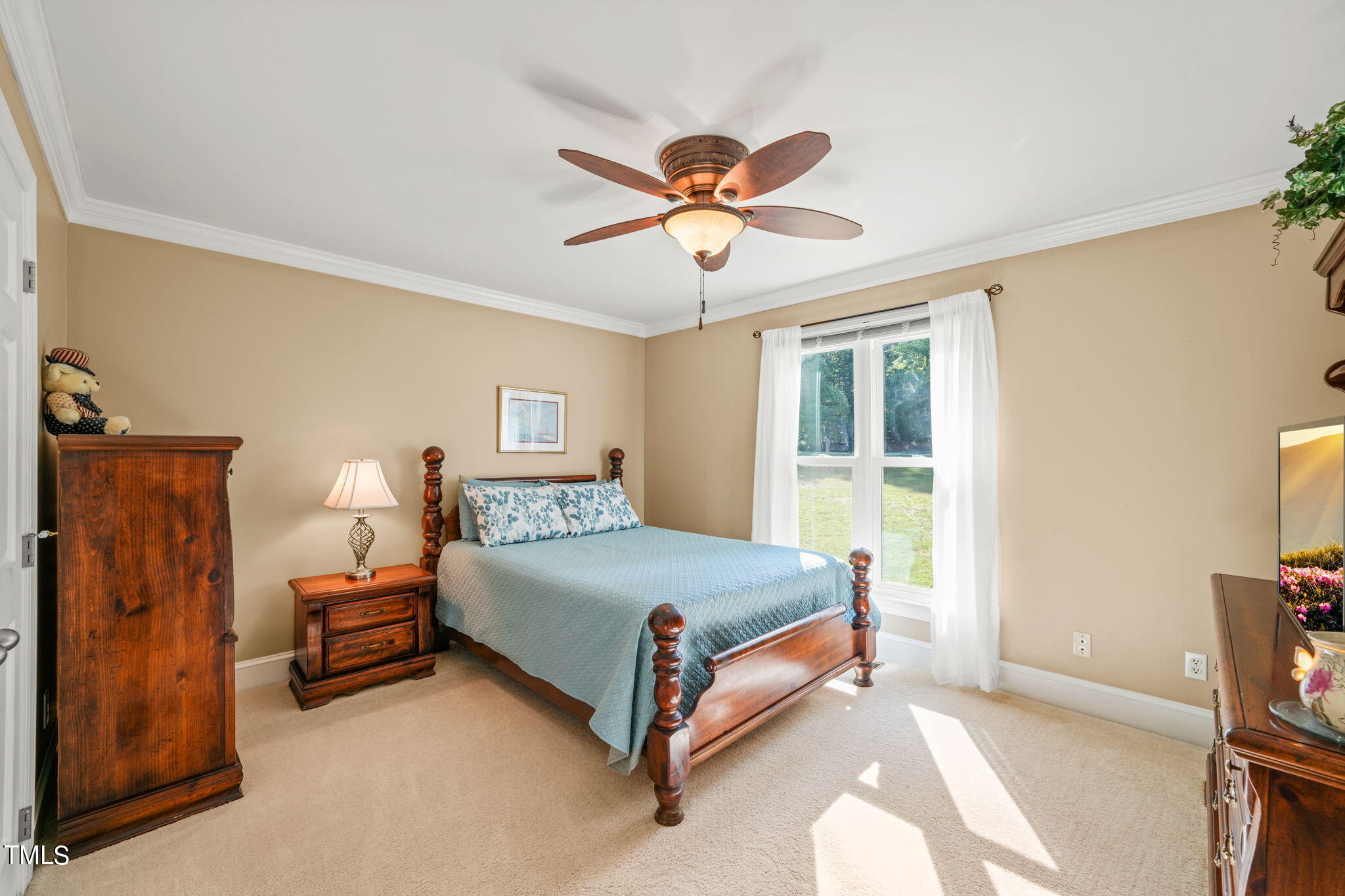 12717 Lindley Drive Raleigh, NC 27614 - Photo 27 of 45 a bedroom with a bed and a chandelier