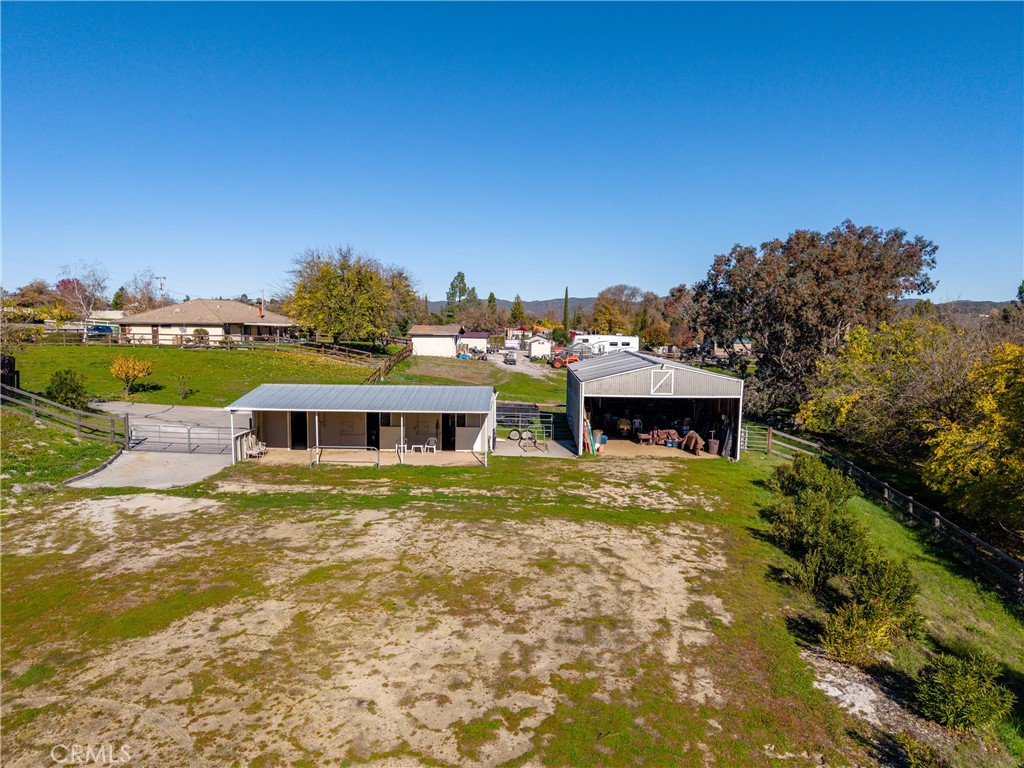 9220 Carmel Road Atascadero, CA 93422 - Photo 46 of 61 The stables and barn share access to the open area which has been used as an arena.