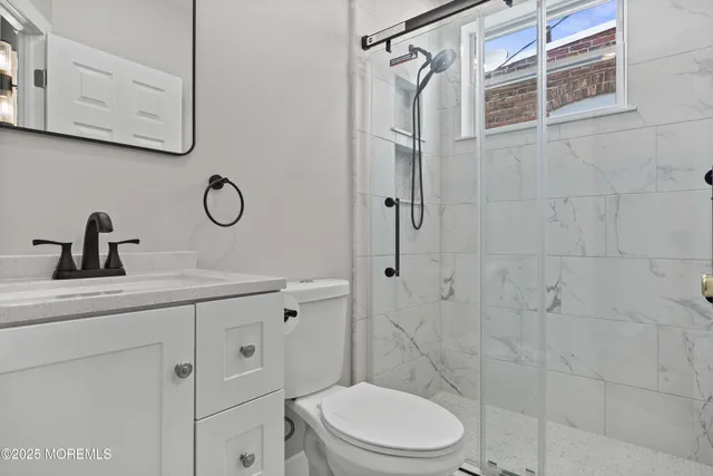 a bathroom with a toilet sink and shower