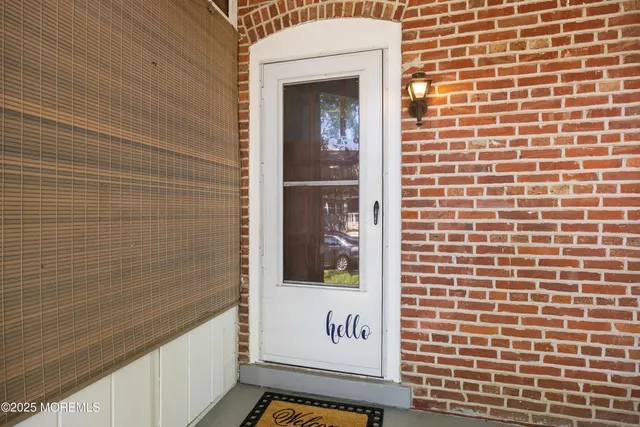 a view of a door and brick wall