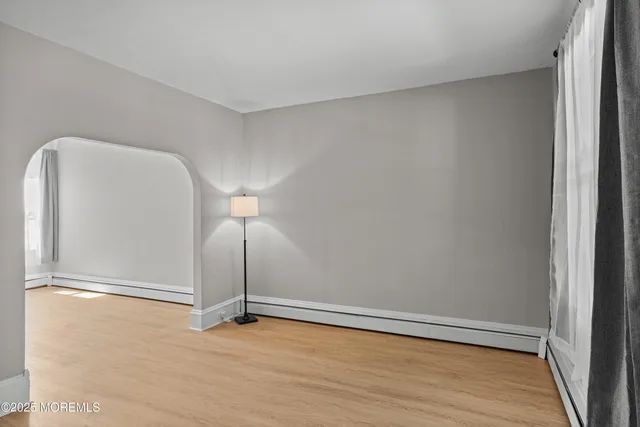 a view of a room with wooden floor