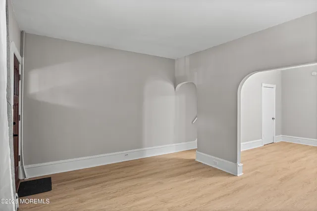 a view of a room with wooden floor