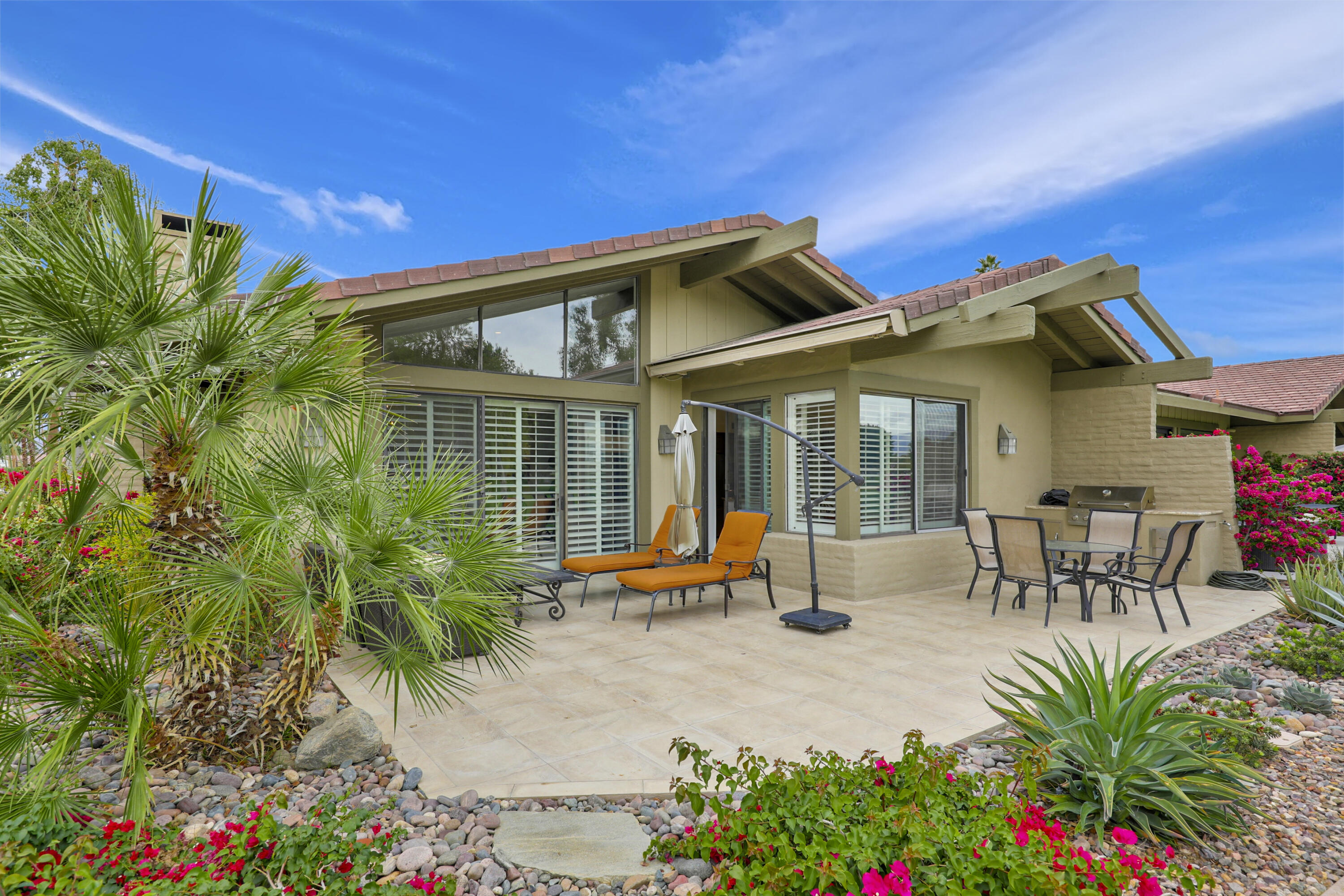 148 Deer Spring Way Palm Desert, CA 92211 - Photo 1 of 54 a view of a house with patio outdoor seating area