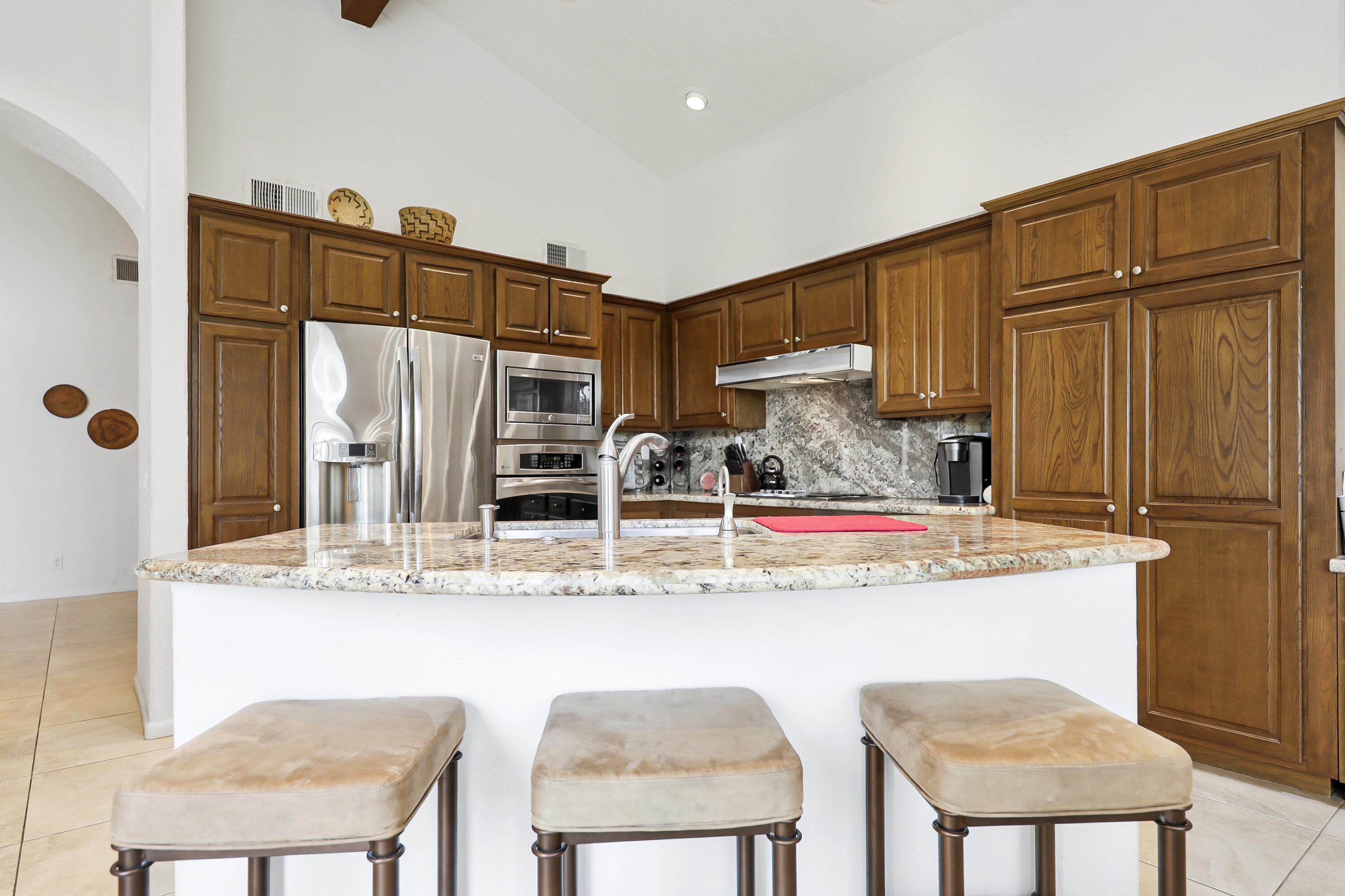 148 Deer Spring Way Palm Desert, CA 92211 - Photo 11 of 54 a kitchen with stainless steel appliances granite countertop a sink and a refrigerator