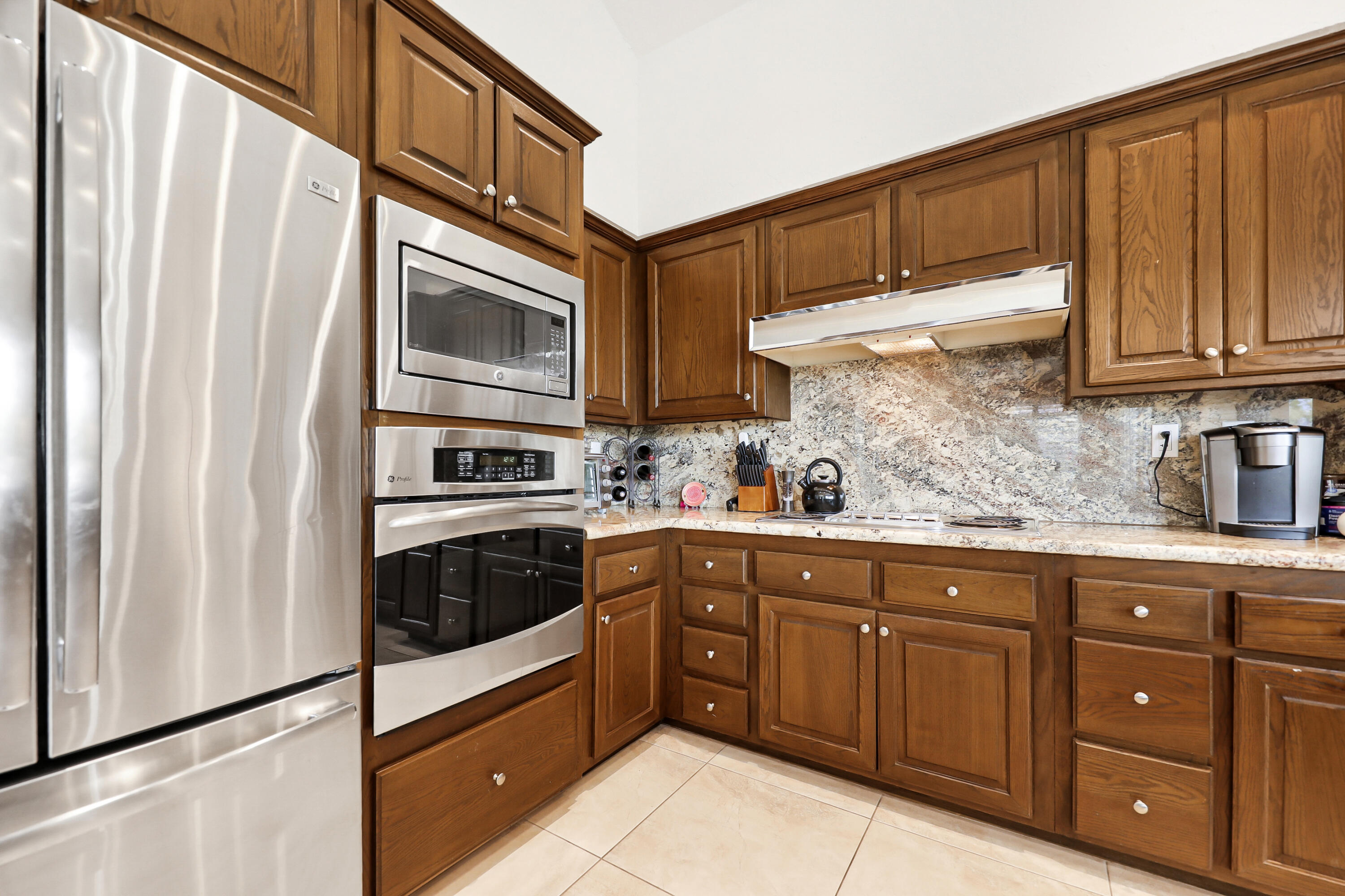 148 Deer Spring Way Palm Desert, CA 92211 - Photo 12 of 54 a kitchen with stainless steel appliances granite countertop a refrigerator and cabinets