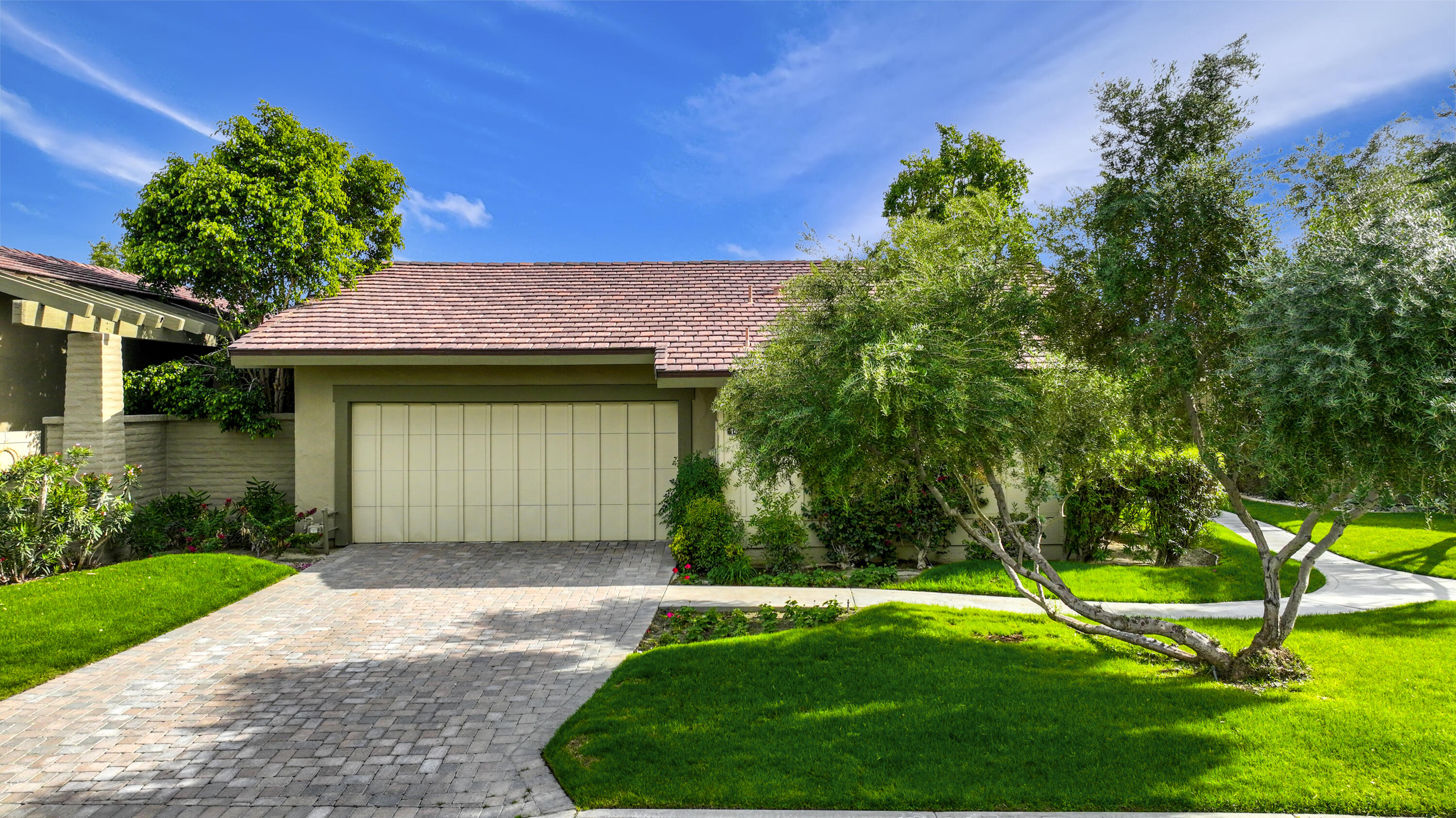 148 Deer Spring Way Palm Desert, CA 92211 - Photo 30 of 54 a front view of a house with a yard and garage