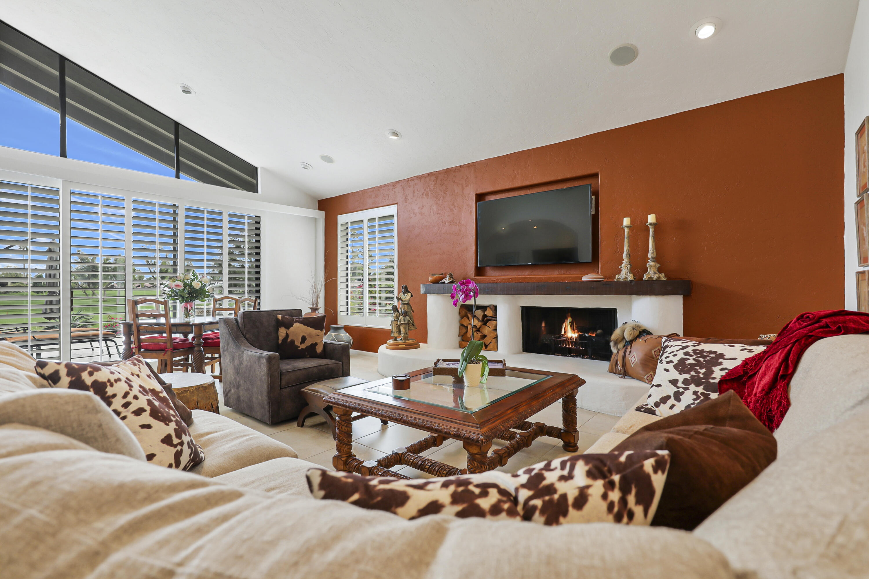 148 Deer Spring Way Palm Desert, CA 92211 - Photo 5 of 54 a living room with furniture a flat screen tv and a fireplace
