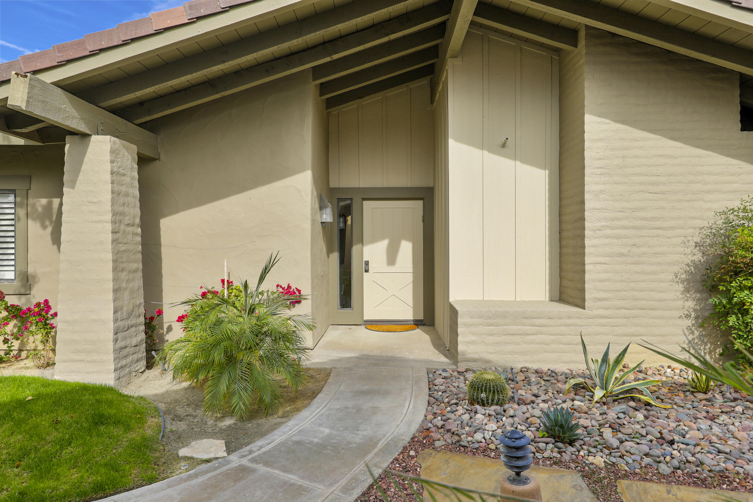 148 Deer Spring Way Palm Desert, CA 92211 - Photo 52 of 54 a front view of a house with a yard