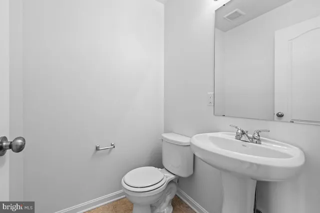 a bathroom with a sink toilet and a mirror