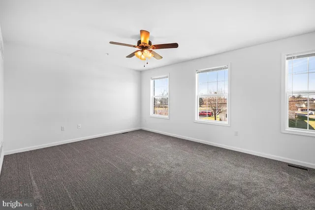 a view of room with a ceiling fan and window
