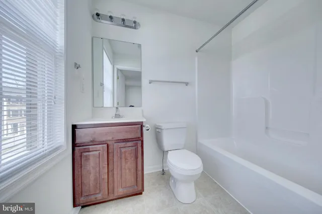 a bathroom with a toilet a sink and bathtub