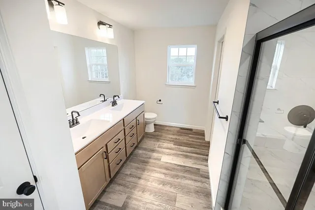 a bathroom with a double vanity sink and mirror
