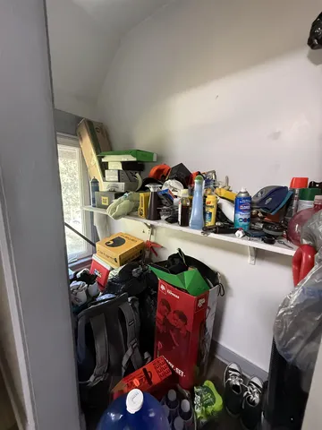 a utility room with lots of clutter and bicycles