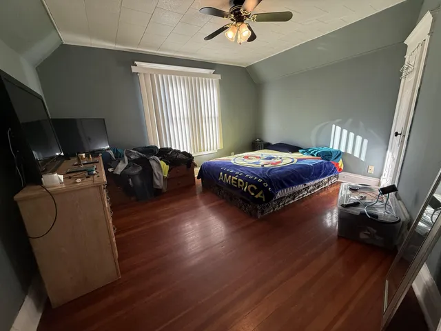 a living room with hard wood flooring and furniture