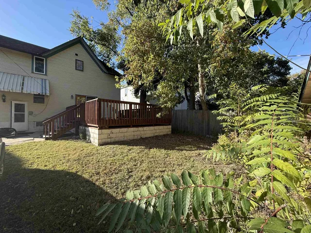 a view of a house with wooden fence
