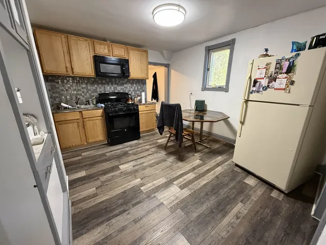 a kitchen with a refrigerator stove and a sink
