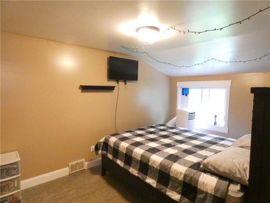 447 Pfeifer Road Prospect, PA 16052 - Photo 11 of 14 a bedroom with a bed and a flat screen tv