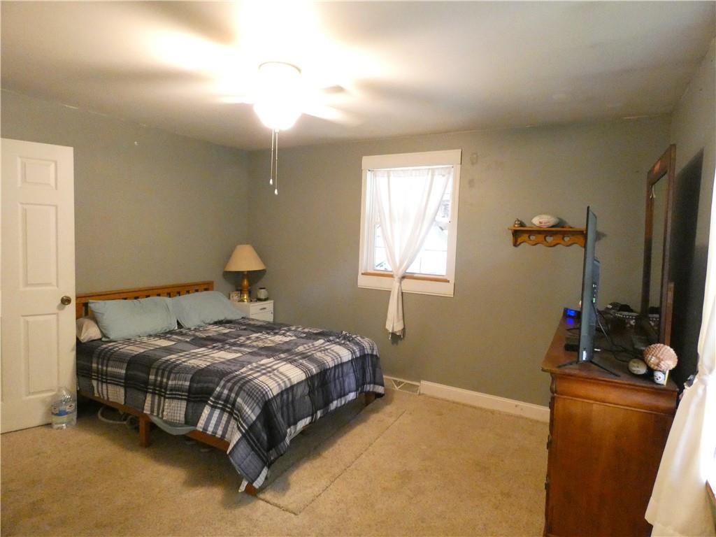 447 Pfeifer Road Prospect, PA 16052 - Photo 9 of 14 a bedroom with a bed and a flat tv screen on the dresser