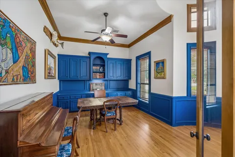 a view of a dining room with furniture a chandelier and wooden floor